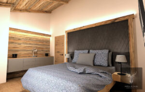 Schlafzimmer mit Headboard aus edlem Stoff und Altholz Verkleidung