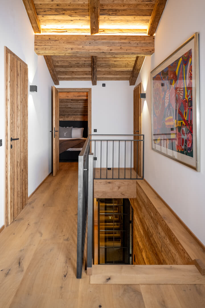 Treppenhaus Chalet mit Eichendielen, Stahlgeländer ud Altholz Decke