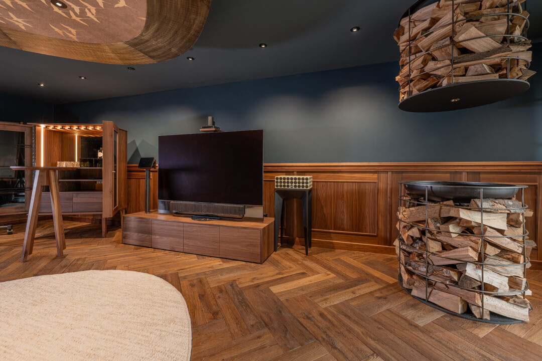 Elegantes Kaminzimmer mit Fischgrätboden, Holz-Lambrisierung an den Wänden im englischen Stil